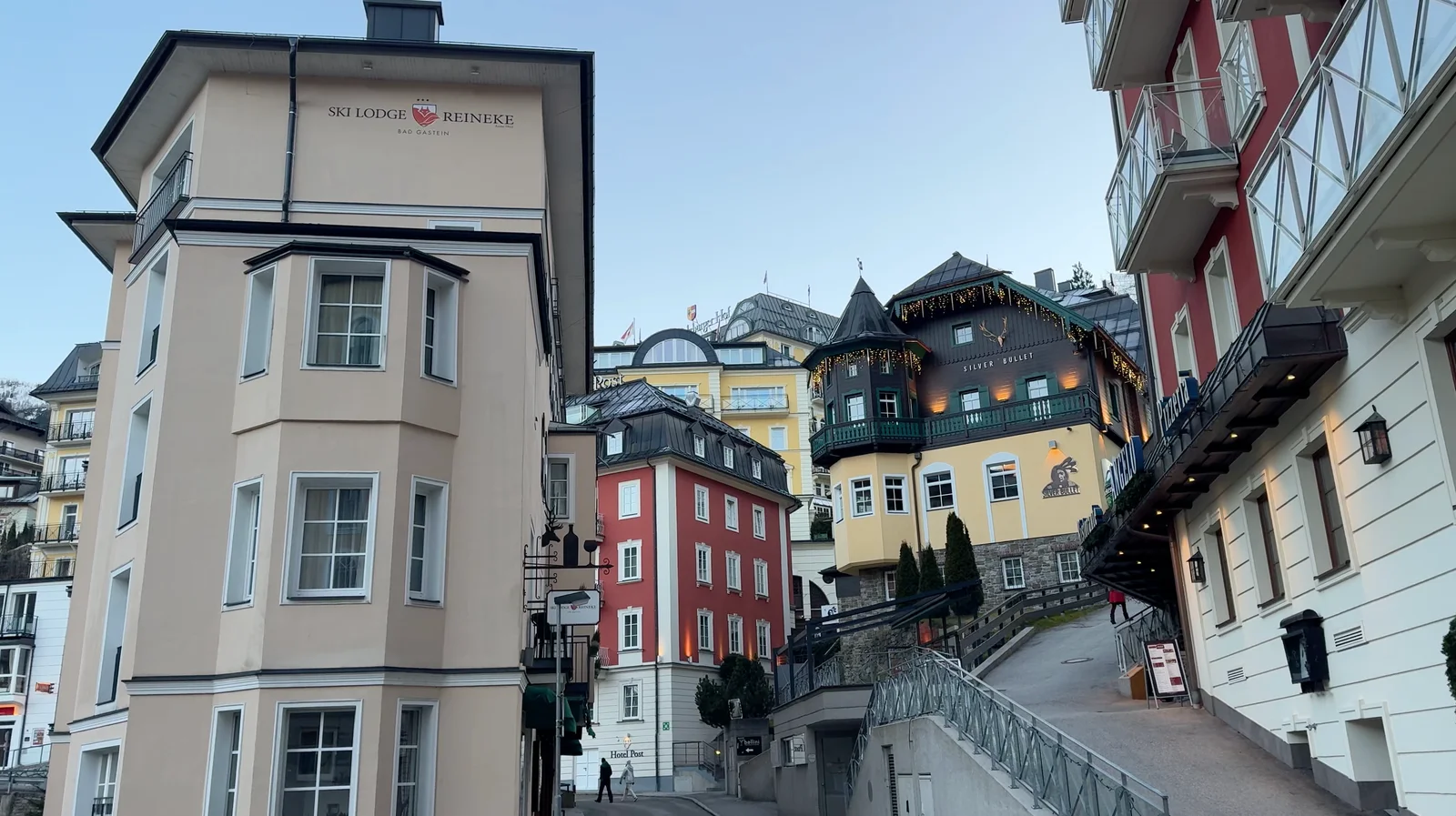 An uphill pedestrian path between colourful buildings in Bad Gastein.