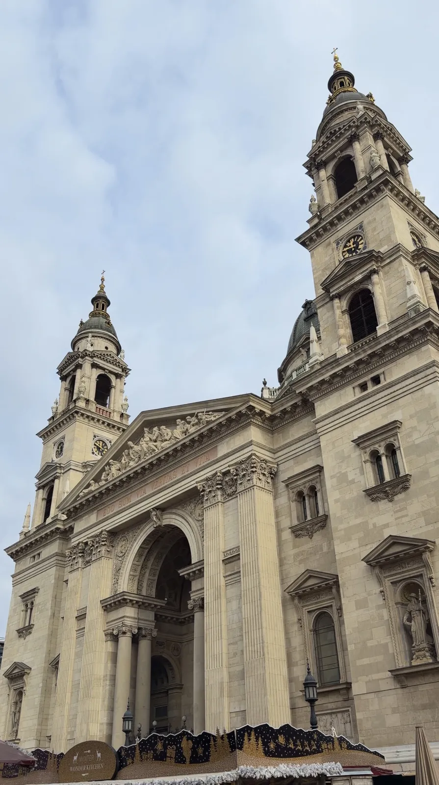 The front of St Stephen's Basilica with two towers and a large arched entrance.