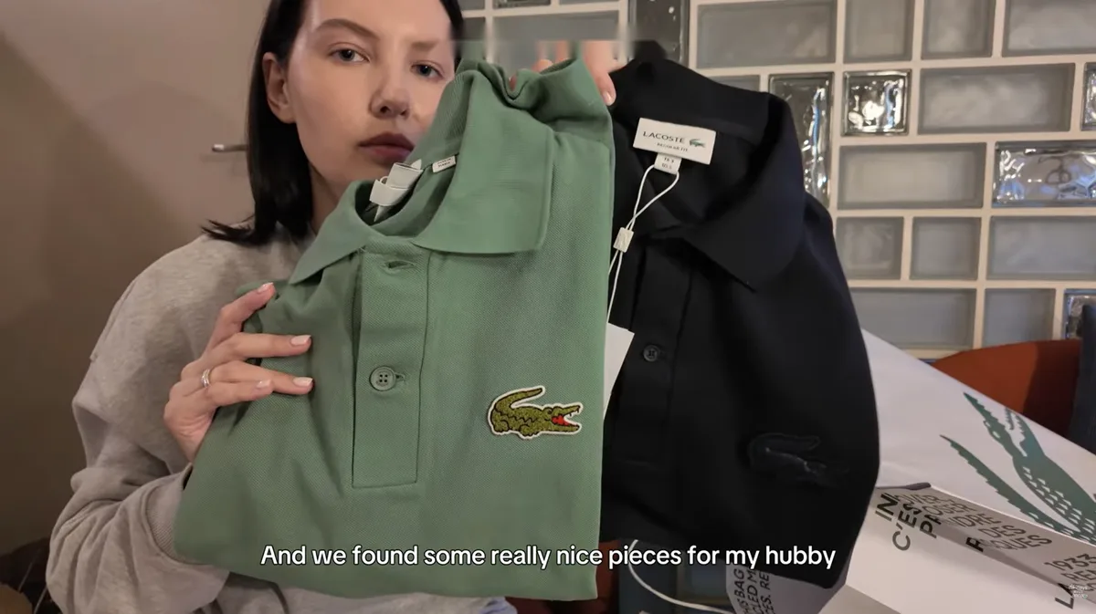 Me holding green and dark Lacoste polo shirts.