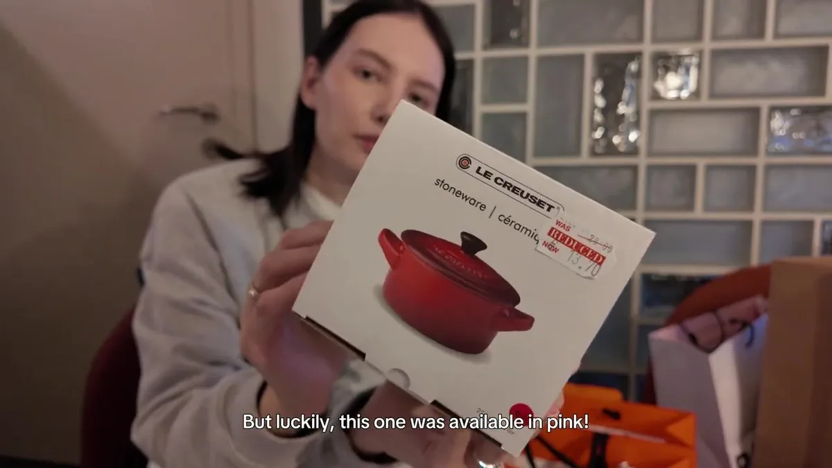 Le Creuset ceramic cocotte box with a reduction label; the illustration on the box is red.