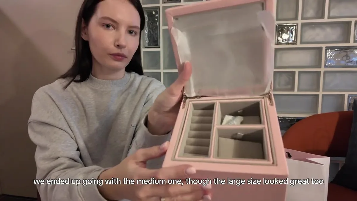 Me showing the open pink Pandora jewellery box with divided storage compartments.