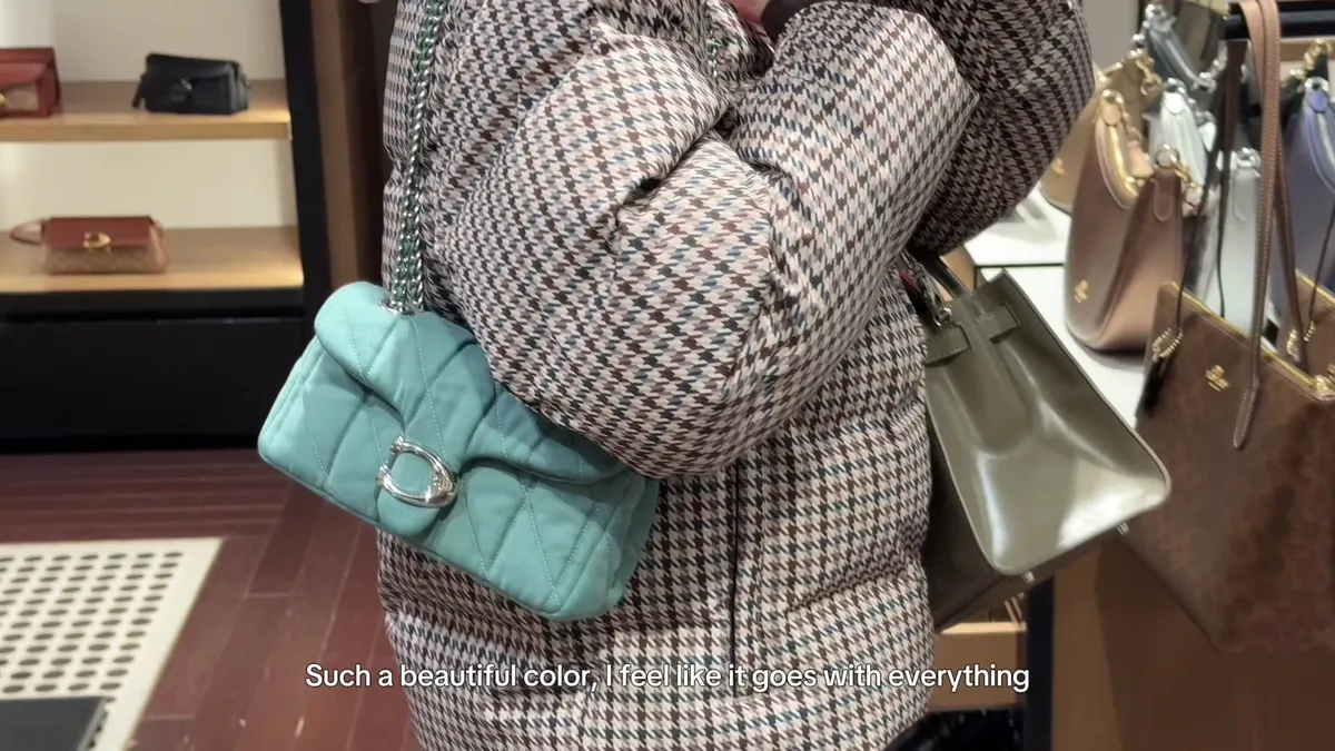 Quilted denim Coach Tabby worn over my shoulder in the shop.