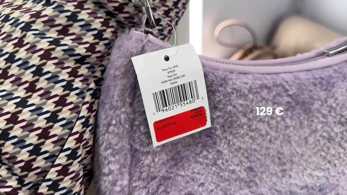 Lilac fluffy Kate Spade Kayla bag with its K1903 label and €129 price.