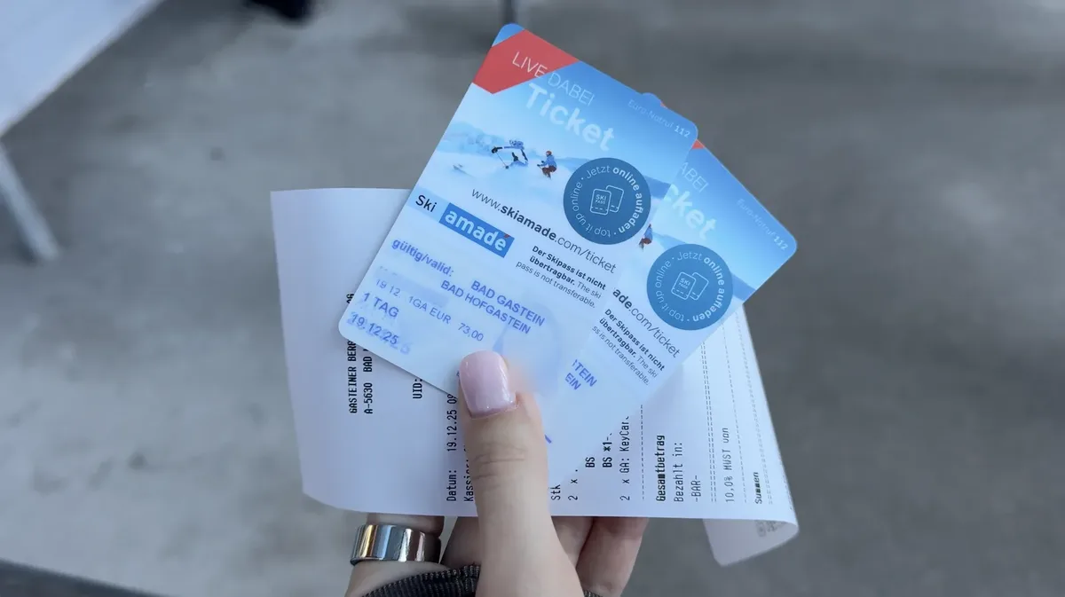 Two physical Ski amadé cards held over a receipt, marked for one day on 19 December 2025, with a fare of 73 euros.