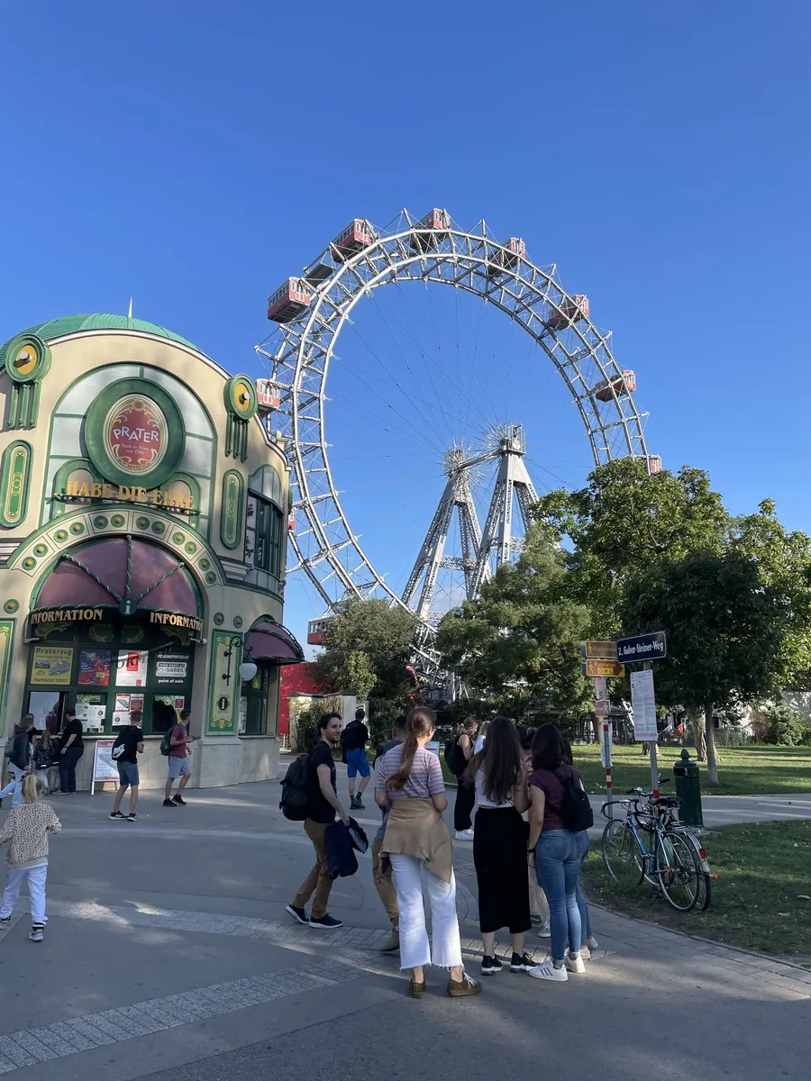 The giant Ferris wheel above the trees beside the Prater information pavilion